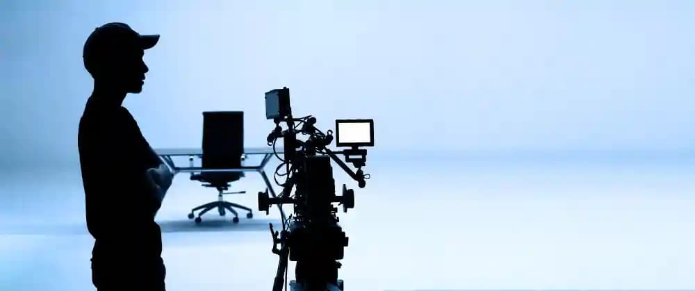 Man holding a camera representing media and communication services